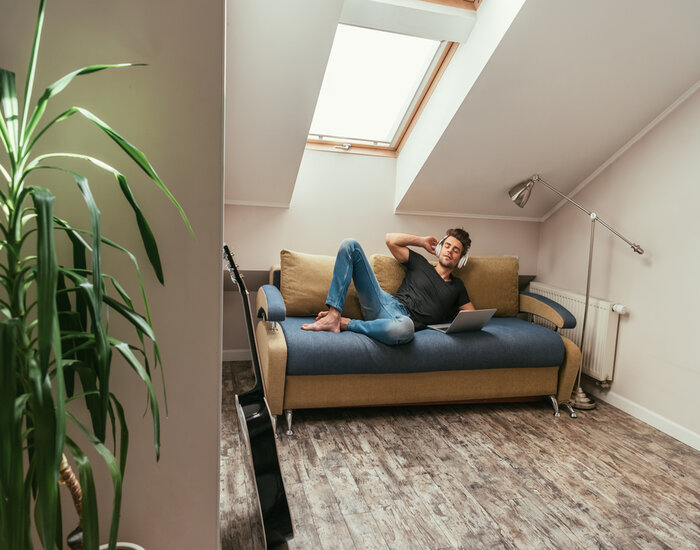 Attic to Living Space: Man in sofa at the attic