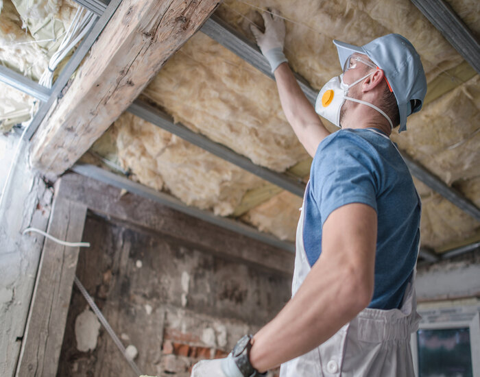 Signs to Replace Your Insulation: Inspecting an old roof insulation